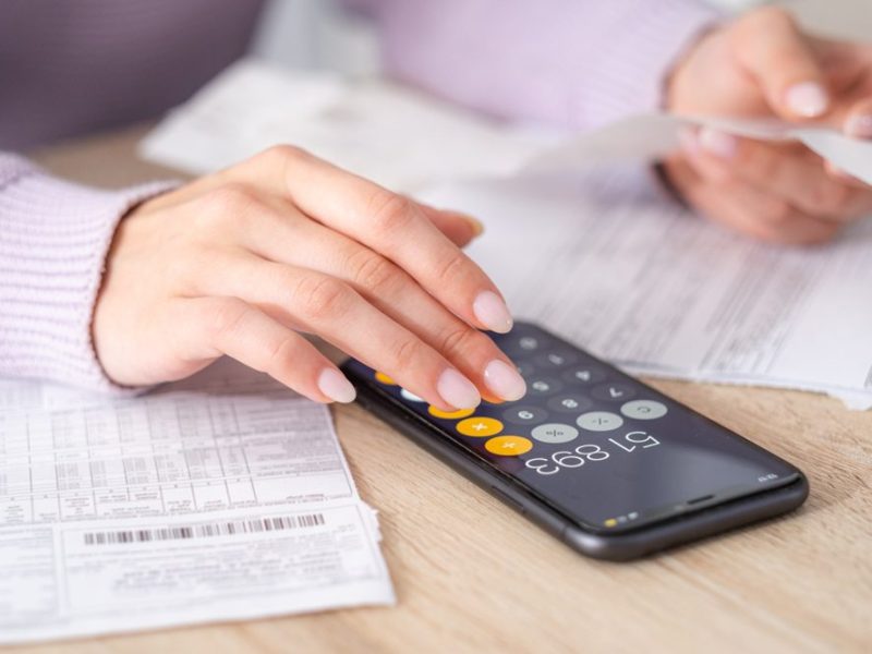 Economical,Woman,Work,On,Phone,Calculator,At,Home,Pay,Bills