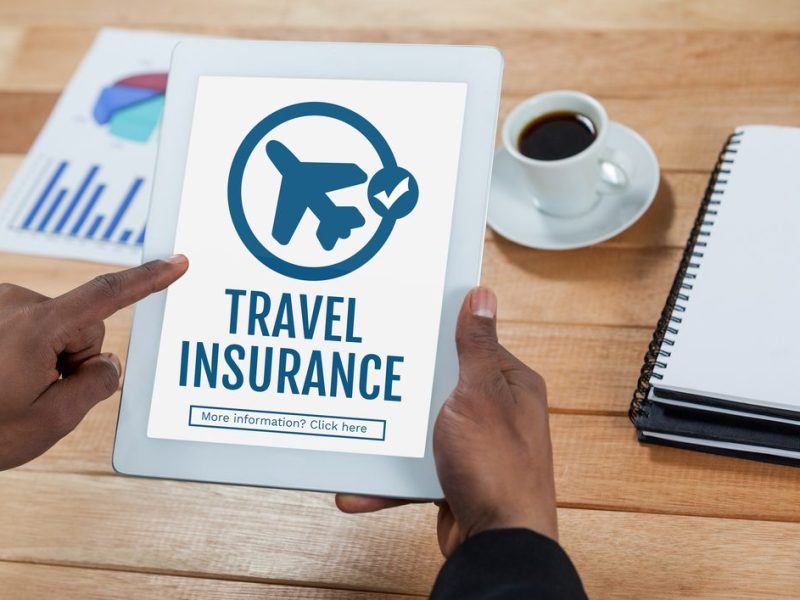 Digital,Composite,Of,Person,Using,A,Tablet,With,Travel,Insurance