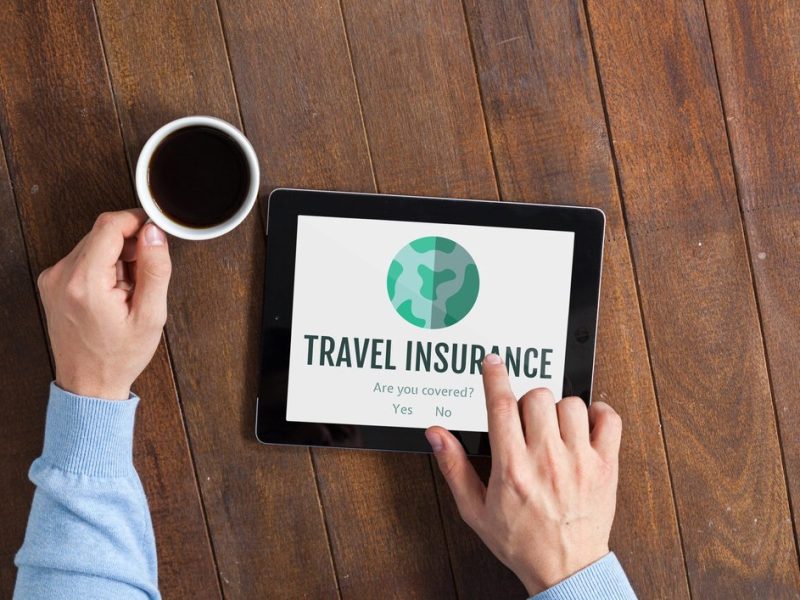 Digital,Composite,Of,Man,Using,A,Tablet,With,Travel,Insurance